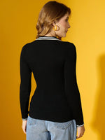 Woman with light brown hair in a 98degreenorth Black Ribbed Collared Knit Sweater, facing away against a yellow background.