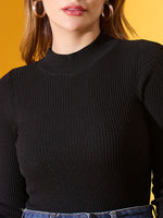 Woman in 98degreenorth Women’s Black Ribbed High-Neck Slim Fit Sweater, posing against a yellow background.