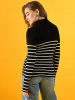 Woman in 98degreenorth black ribbed striped turtleneck sweater, Winterwear India Online, poses against yellow backdrop.
