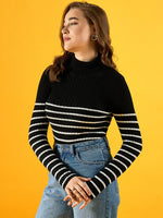 A woman in a 98degreenorth Women’s Black Ribbed Striped Turtleneck Sweater stands against a yellow background.