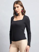 Modern Indian woman in 98degreenorth Women's Black Square Neck Long Sleeve Top, beige pants, and red earrings.