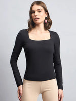 A modern Indian woman wears the 98degreenorth Women’s Black Square Neck Long Sleeve Top and pink geometric earrings.