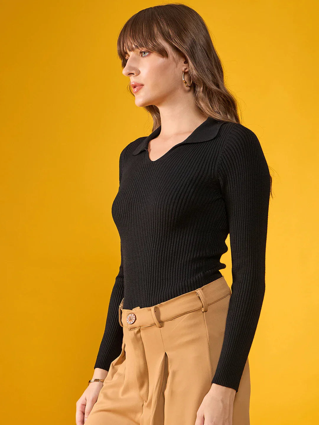 Woman in 98degreenorth Women’s Black Stretchable Ribbed Collar Sweater poses against a solid yellow background.