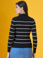Model in 98degreenorth Women’s Black Striped Collared Knit Sweater and jeans, posed before a yellow backdrop.