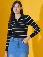 Woman wears 98degreenorth Black Striped Collared Knit Sweater with blue skirt, posing by a yellow background.