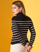 Woman wears 98degreenorth black striped ribbed high neck sweater; yellow background for bold contrast.