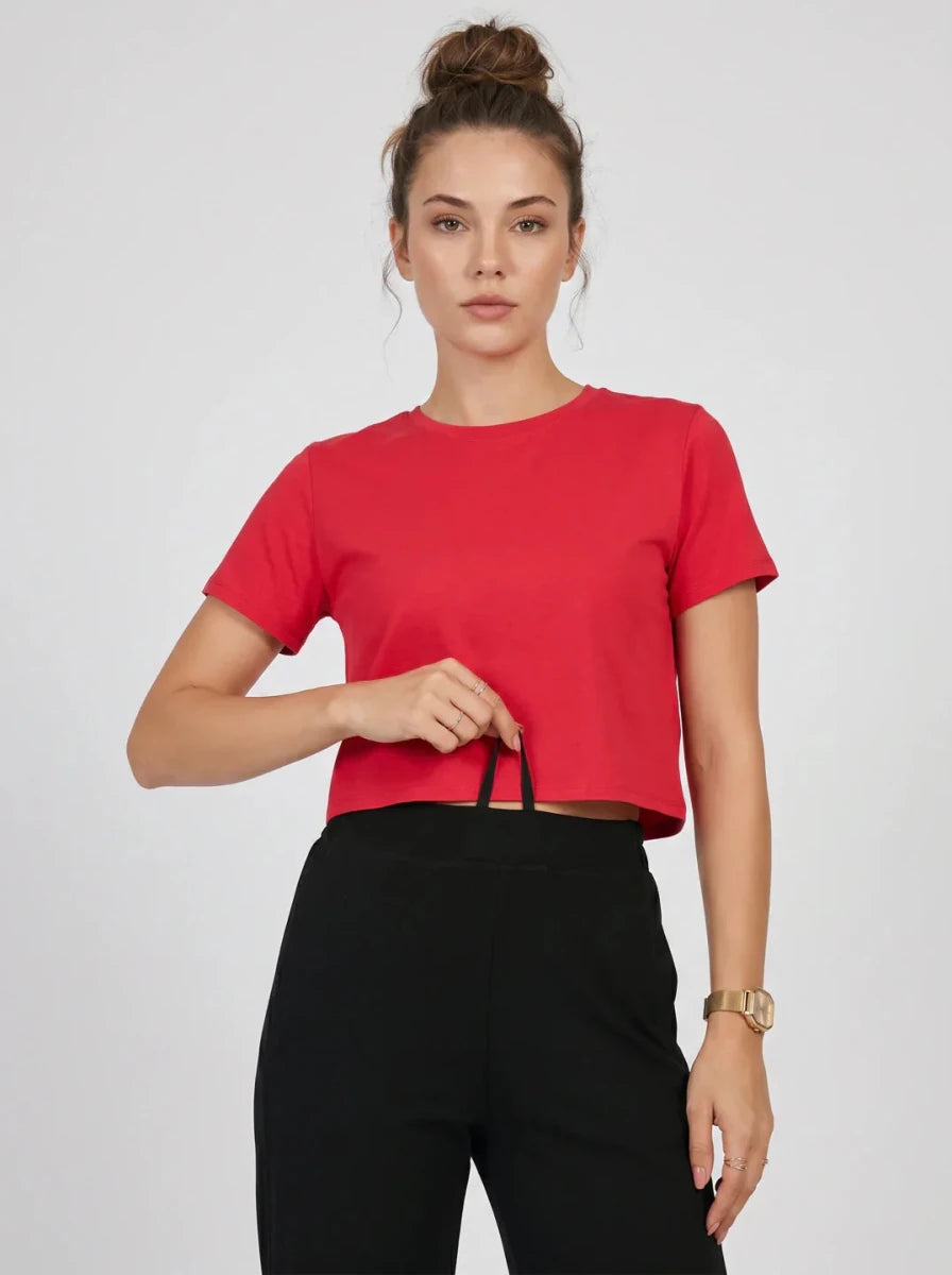 Woman in 98degreenorth black high-rise wide-leg cotton pants adjusts drawstrings against a plain backdrop.