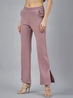 Woman in 98degreenorth Blush Pink Bootcut Sweatpants with side slits, pockets, and beige heeled sandals.