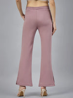 Model wears 98degreenorth Women’s Blush Pink Bootcut Sweatpants with beige heels, shown from the back on gray background.