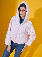 A woman poses in a 98degreenorth Women’s Blush Pink Faux Fur Jacket against a bright yellow background.