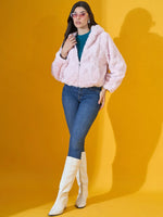 Woman in 98degreenorth blush pink faux fur jacket, blue jeans, and white boots—chic winter fashion for India.