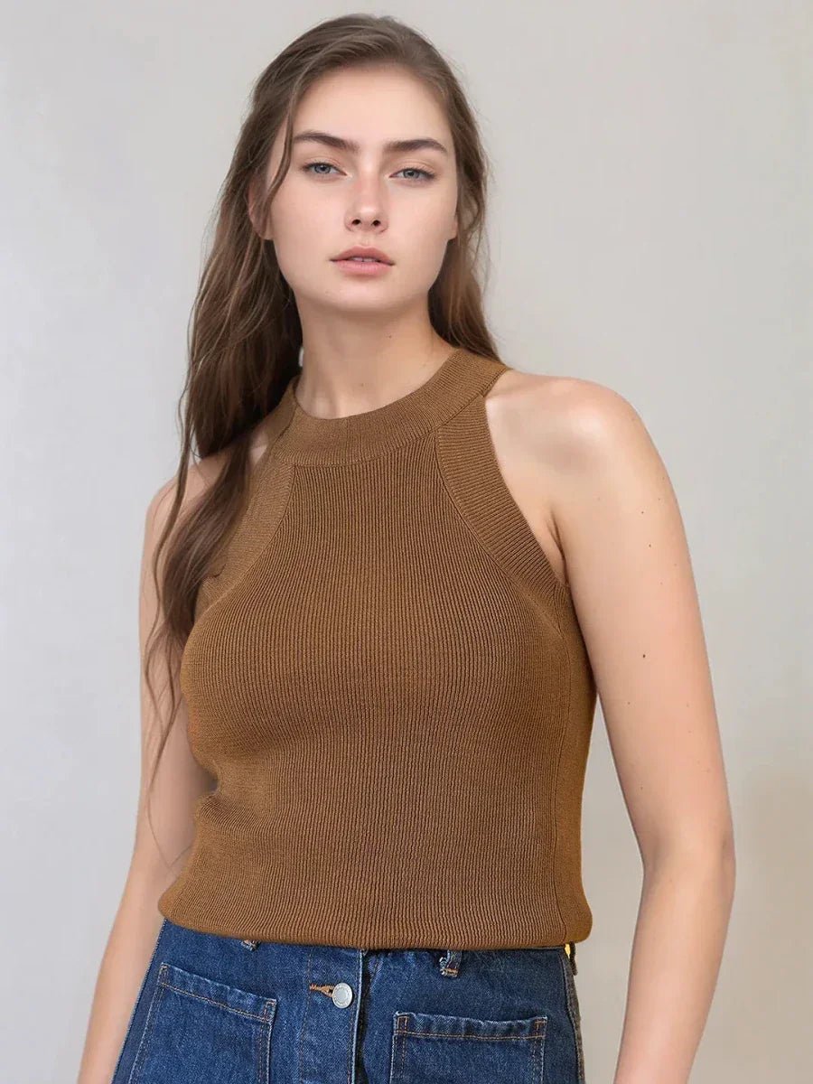 Woman wears 98degreenorth Women’s Brown Ribbed Halter Neck Sleeveless Knit Top with blue jeans against a plain background.