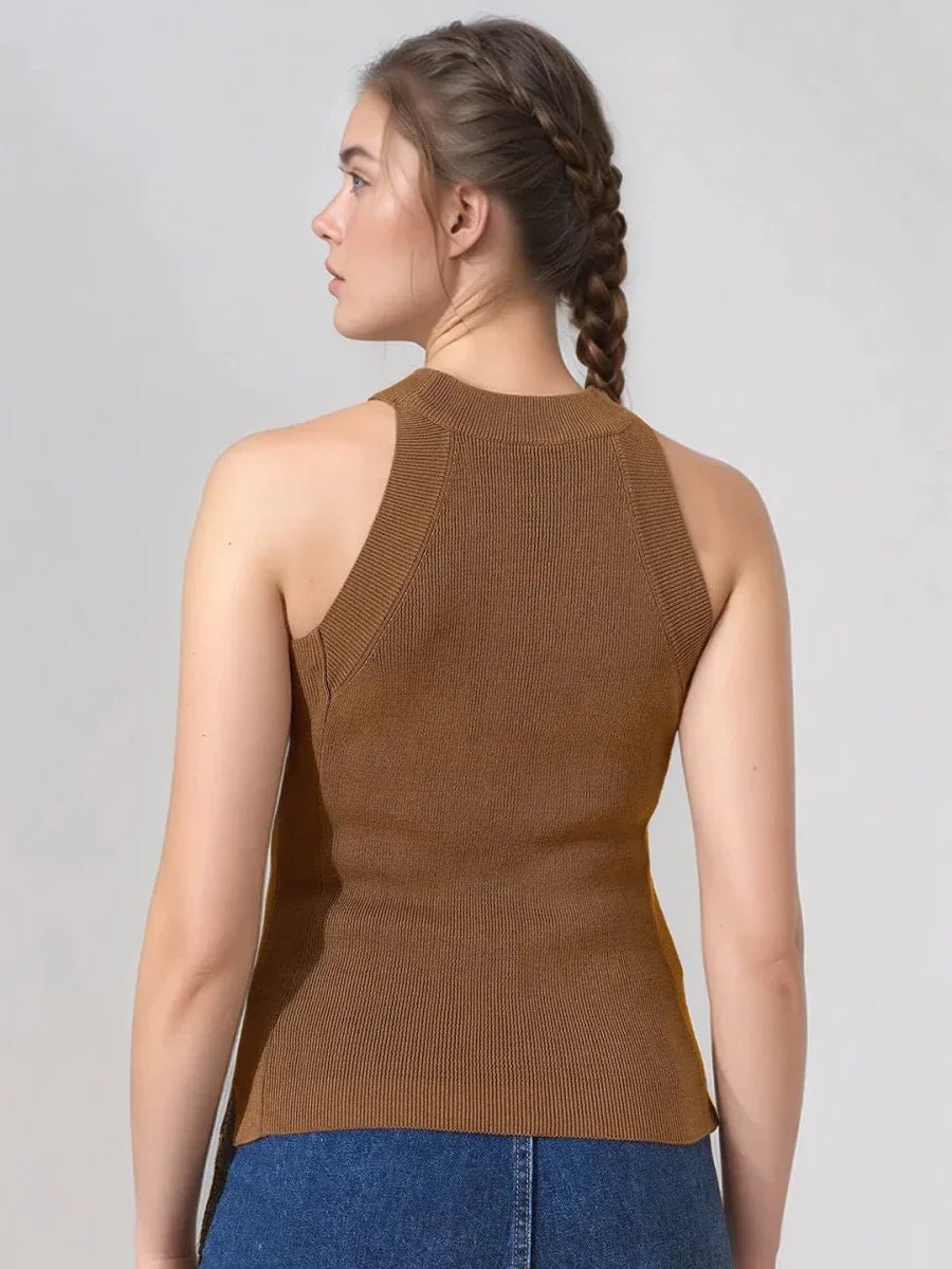 A woman with braided hair wears a 98degreenorth brown ribbed halter neck sleeveless knit top, facing away.