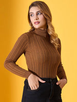 Woman models 98degreenorth brown ribbed turtleneck slim fit sweater, posing against a yellow backdrop.
