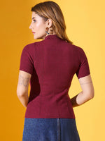 Woman wears 98degreenorth’s burgundy ribbed slim fit turtle neck sweater with a denim skirt against a yellow background.