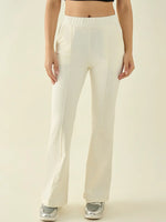 Woman wears 98degreenorth Women’s Butter Flared Bootcut Cotton Stretchable Trousers with sneakers, neutral background.