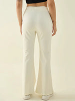 Model wears 98degreenorth Women’s Butter Flared Fit Bootcut Cotton Stretchable Trousers in pastel, shown from the back.