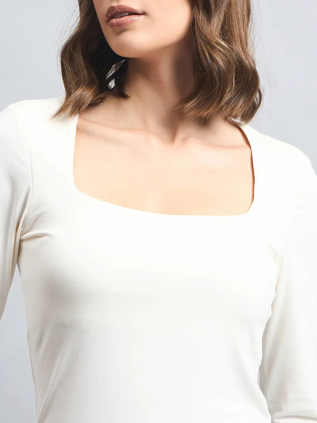 Indian woman wears the 98degreenorth Women’s Butter Square Neck Long Sleeve Top, shown shoulders to above chest.