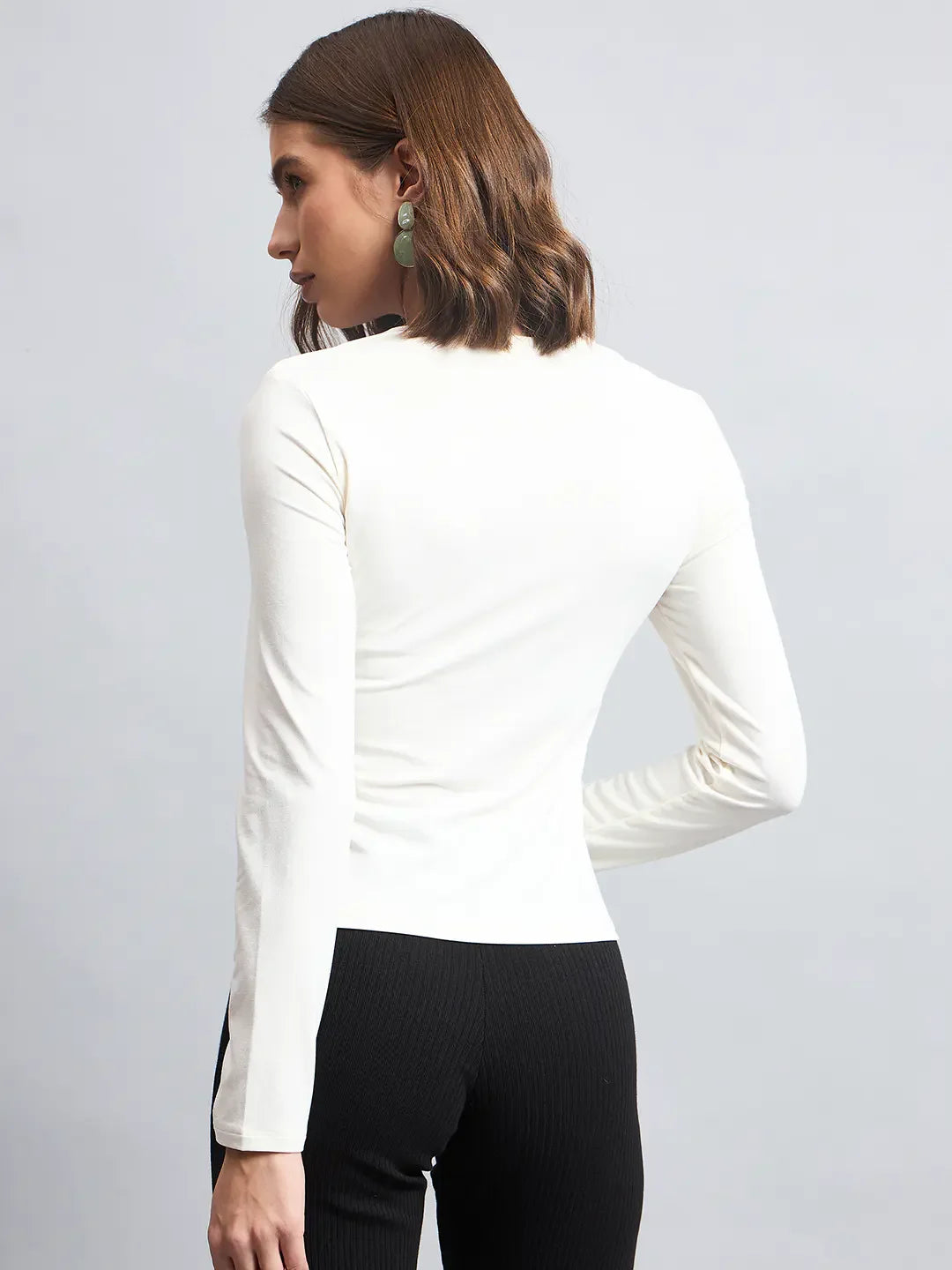 Woman with chin-length brown hair in a 98degreenorth Butter Square Neck Long Sleeve Top and black pants, seen from the back.