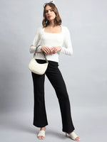 A woman in 98degreenorth’s Women’s Butter Square Neck Long Sleeve Top poses with heels and a small white handbag.
