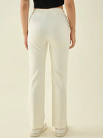 Model in 98degreenorth Women’s Butter Straight Fit Cotton Stretchable Trousers and sneakers, back view.