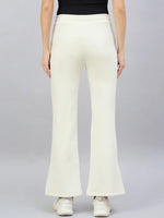 Person in 98degreenorth Women’s Butter Yellow Flared Bootcut Sweatpants and white sneakers, back view on grey background.