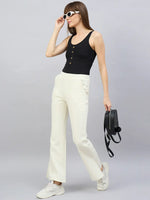 Woman in sunglasses and black top wears 98degreenorth Butter Yellow Flared Bootcut Sweatpants, holding a black backpack.