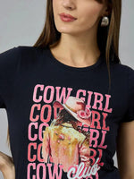 Woman in a 98degreenorth Women’s casual typography t-shirt, 100% cotton, with COWGIRL CLUB and cowgirl graphic on front.