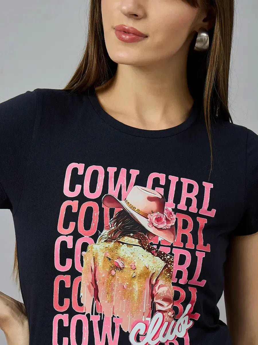 Woman in a 98degreenorth Women’s casual typography t-shirt, 100% cotton, with COWGIRL CLUB and cowgirl graphic on front.