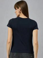 Woman with straight brown hair in a 98degreenorth cotton typography t-shirt and dark jeans, shown from the back.