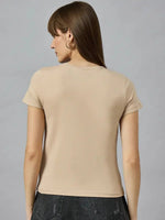 Woman with straight brown hair wears a 98degreenorth Women’s casual typography t-shirt and dark jeans, facing away.