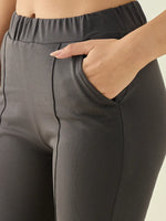 Close-up of a person wearing 98degreenorth Women’s Charcoal Flared Bootcut Cotton Stretchable Trousers.