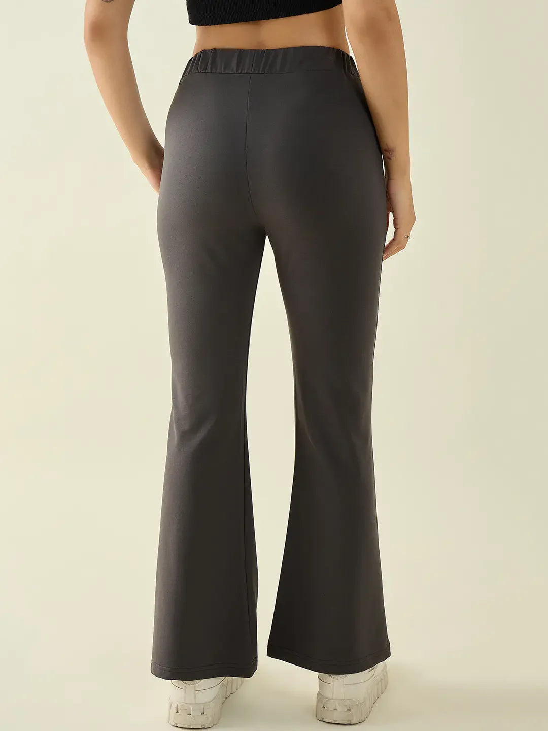 A person shown from the back in 98degreenorth Women's Charcoal Flared Bootcut Cotton Stretchable Trousers.