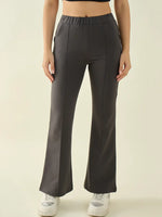 Woman wears 98degreenorth charcoal flared bootcut trousers with a black crop top and white sneakers, facing forward.