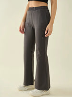 Person wearing 98degreenorth Women’s Charcoal Flared Fit Bootcut Cotton Trousers, black top & white sneakers.