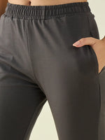 Model wears 98degreenorth Women’s Charcoal Flared Fit Bootcut Cotton Stretchable Trousers with elastic waistband.