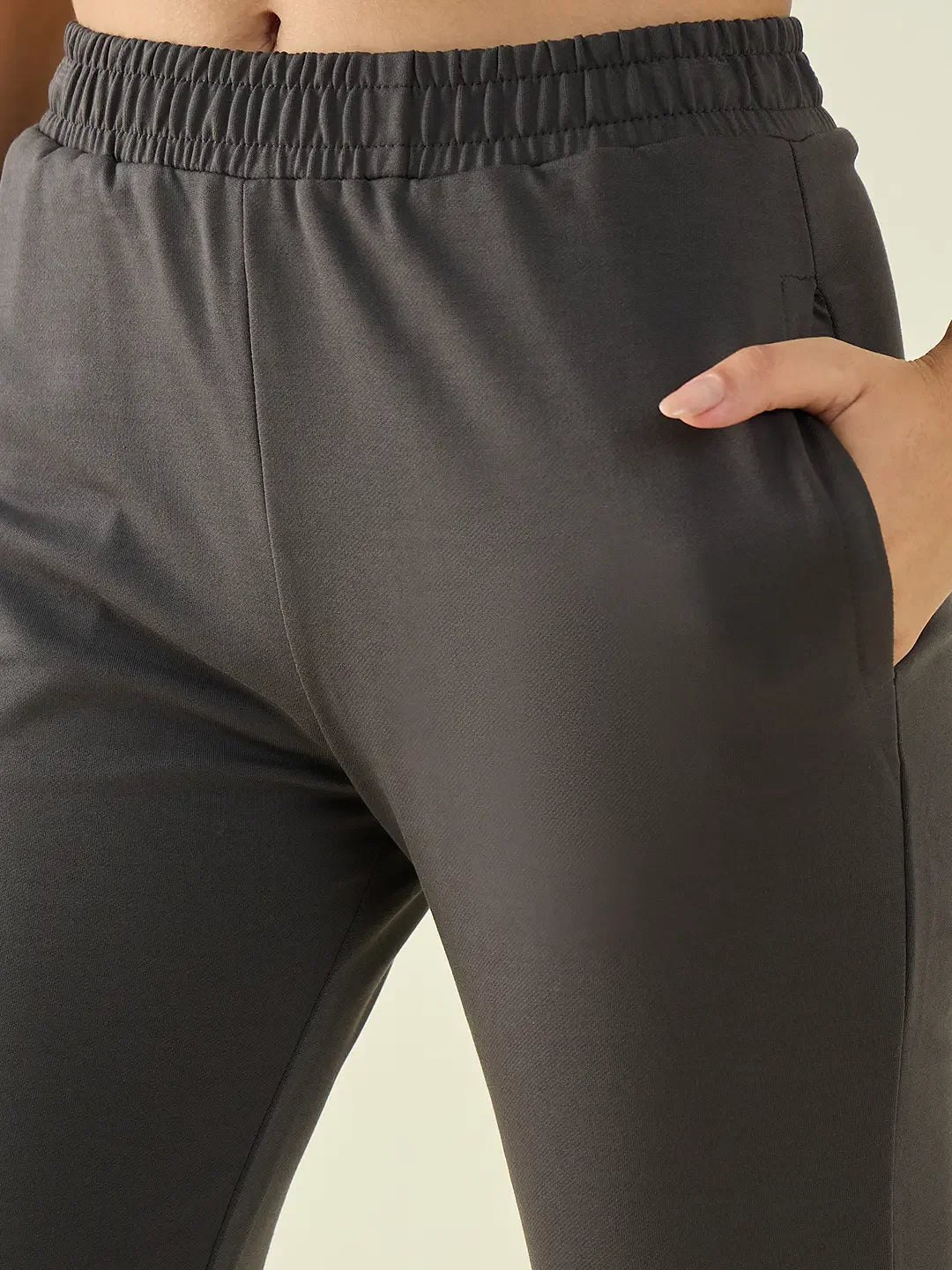 Model wears 98degreenorth Women’s Charcoal Flared Fit Bootcut Cotton Stretchable Trousers with elastic waistband.
