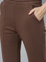 Close-up of 98degreenorth Women’s Cocoa Brown Bootcut Sweatpants with stitched seams and a hand in the pocket.