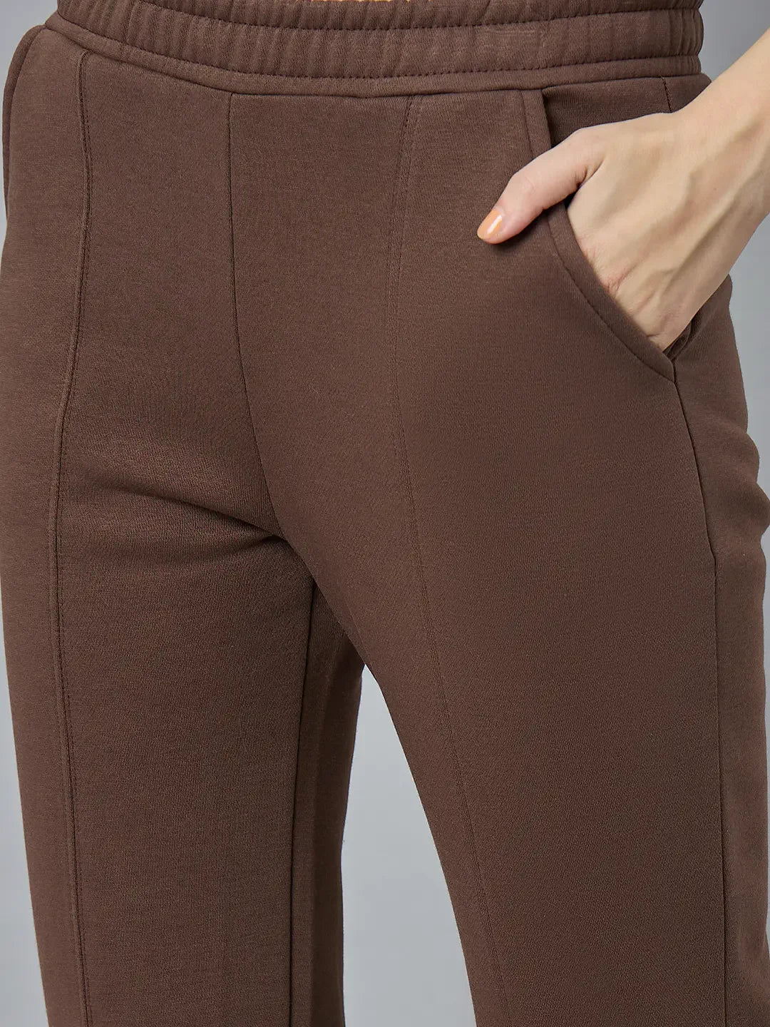 Close-up of 98degreenorth Women’s Cocoa Brown Bootcut Sweatpants with stitched seams and a hand in the pocket.
