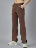 A woman in 98degreenorth Cocoa Brown Flared Bootcut Sweatpants with side-slits, paired with white sneakers.