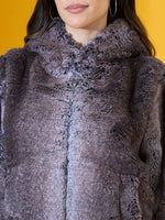 Woman in a 98degreenorth coffee brown faux fur jacket—a cozy winter layer for cold evenings and getaways.