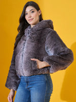 Woman in 98degreenorth Coffee Brown Faux Fur Jacket poses in cozy winter style against a yellow background.