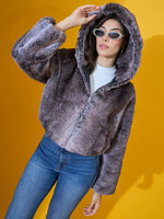 Woman in 98degreenorth’s Coffee Brown Faux Fur Jacket poses stylishly against a bold yellow background.
