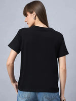 Woman with long brown hair wears a 98degreenorth Cotton Typography Graphic Tee and blue jeans, shown from the back.