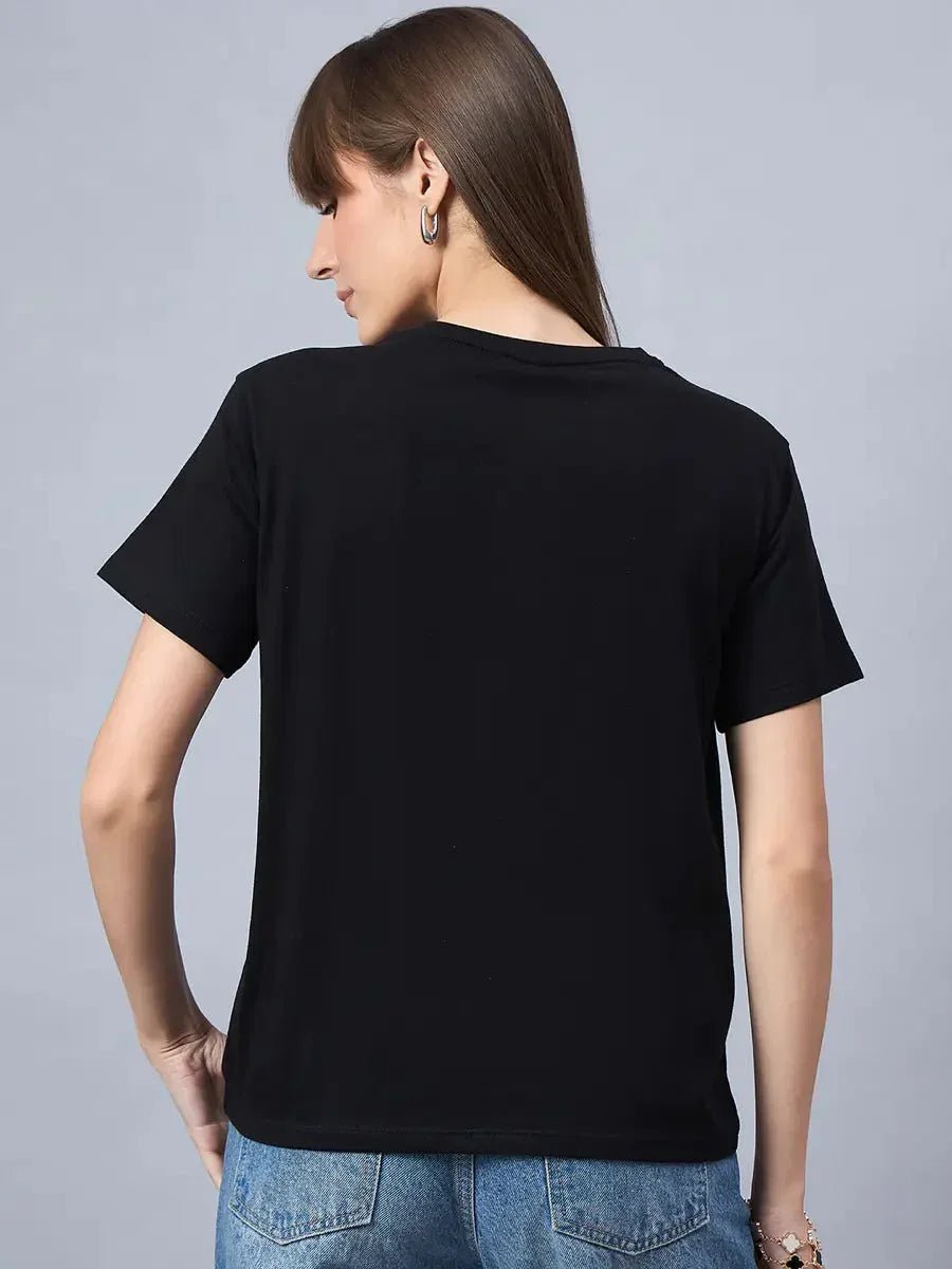 Woman with long brown hair wears a 98degreenorth Cotton Typography Graphic Tee and blue jeans, shown from the back.