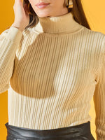 Woman wears 98degreenorth Cream Ribbed Turtleneck Sweater, posing against a yellow background in a black skirt.
