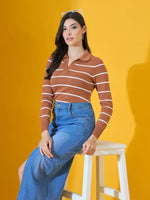 Woman wears a 98degreenorth Dark Camel Striped Collared Sweater, seated on a white stool with a yellow backdrop.