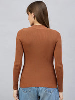 Woman in 98degreenorth’s Dark Camel Turtle Neck Ribbed Sweater, facing away, styled with blue jeans.