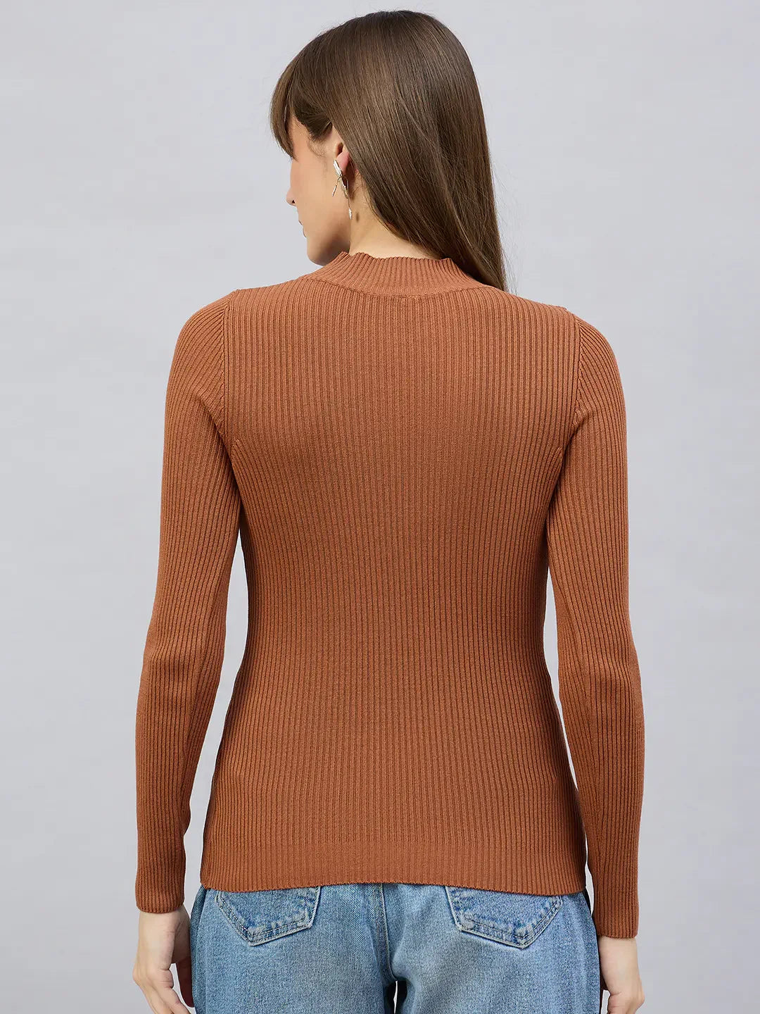 Woman in 98degreenorth’s Dark Camel Turtle Neck Ribbed Sweater, facing away, styled with blue jeans.