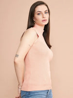 Woman in 98degreenorth’s dark pink ribbed high neck slim fit tank and blue jeans, against a beige background.